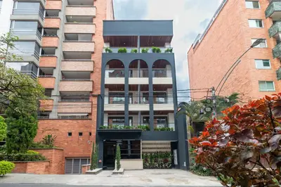 an apartment building with a balcony in a city at Opera Living by HOUSY in Medellín