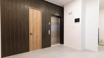a hallway with a wooden door in a room at Opera Living by HOUSY in Medellín