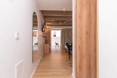 a hallway leading to a living room with a mirror at Opera Living by HOUSY in Medellín