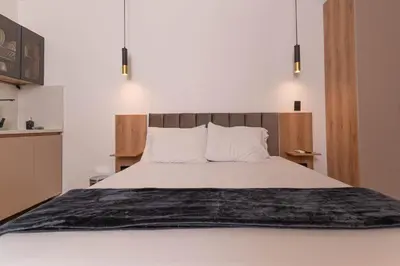 a bedroom with a large bed with a black blanket at Opera Living by HOUSY in Medellín