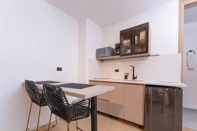 a kitchen with a table and chairs in a room at Opera Living by HOUSY in Medellín