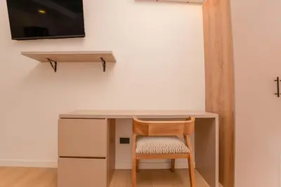 a desk and a chair under a desk at Opera Living by HOUSY in Medellín