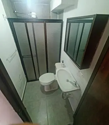 a small bathroom with a toilet and a sink at Apartaestudio en laureles la castellana in Medellín