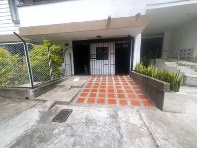 an entrance to a building with an orange checkered floor at Apartaestudio en laureles la castellana in Medellín