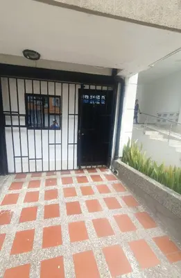 an entrance to a building with a black door at Apartaestudio en laureles la castellana in Medellín