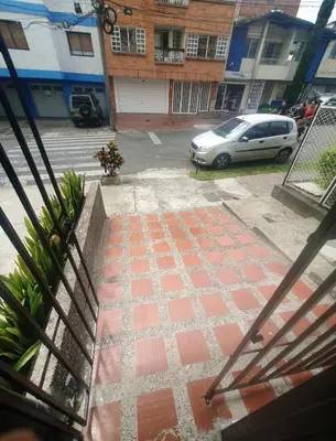 a view of a parking lot with a white car at Apartaestudio en laureles la castellana in Medellín