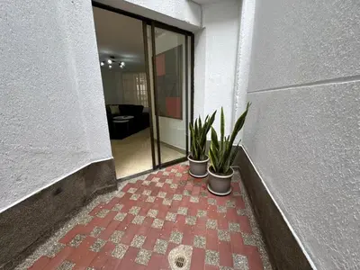 two potted plants on a brick floor in a hallway at Apartamento en Laureles- Avenida Nutibara in Medellín