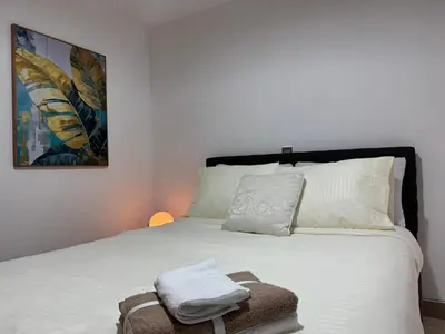 a bedroom with a white bed with a towel on it at Apartamento en Laureles- Avenida Nutibara in Medellín