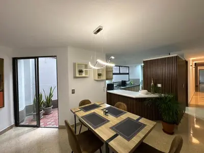 a dining room and kitchen with a table and chairs at Apartamento en Laureles- Avenida Nutibara in Medellín