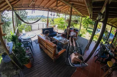 a group of people sitting on a deck at El Paraíso Tropical in La Pradera