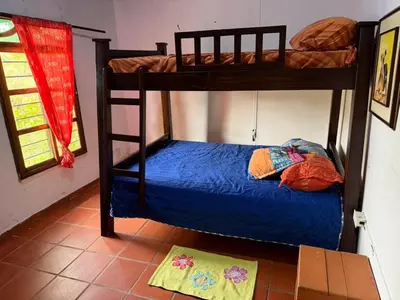 a bedroom with two bunk beds in a room at El Paraíso Tropical in La Pradera
