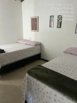 two beds sitting in a room with at Hermoso Apartasol en Santa Fe de Antioquia!!! in Santa Fe de Antioquia