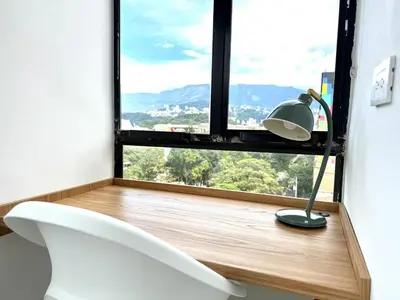 a room with a window with a white toilet and a lamp at Cozy Studio 703 Heart of Laureles in Medellín