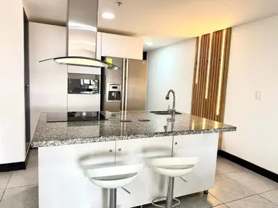a kitchen with a sink and a counter with stools at Cozy Studio 703 Heart of Laureles in Medellín