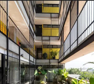 an external view of a building with windows and plants at Cozy Studio 703 Heart of Laureles in Medellín