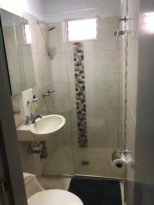 a bathroom with a shower and a sink and a toilet at Individual studio apartment 2 in Medellín