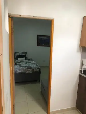 a door leading into a bedroom with a bed at Individual studio apartment 2 in Medellín