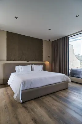 a bedroom with a large bed and a large window at Roka Hotel in Guatapé