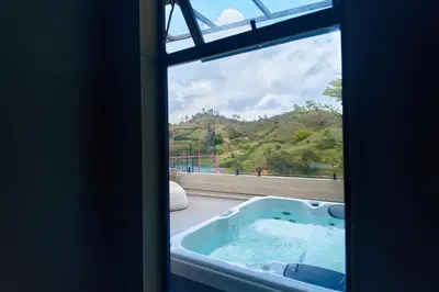 a bath tub in a room with a window at Roka Hotel in Guatapé