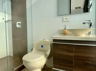 a bathroom with a toilet and a sink at 2003 Poblado TOP apartamento in Medellín