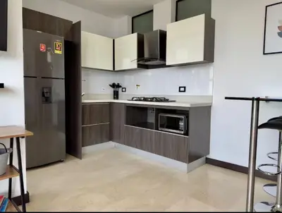 a kitchen with white cabinets and a stainless steel refrigerator at 2003 Poblado TOP apartamento in Medellín