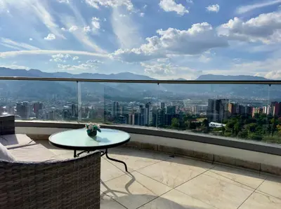 a balcony with a table and a view of a city at 2003 Poblado TOP apartamento in Medellín