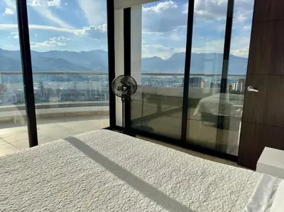 a bedroom with a large window with a view at 2003 Poblado TOP apartamento in Medellín