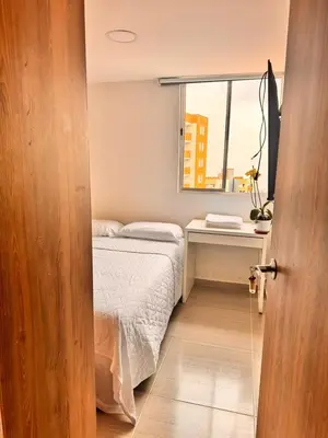 a small bedroom with a bed and a window at Espectacular Habitacion Privada en Apartamento in Medellín
