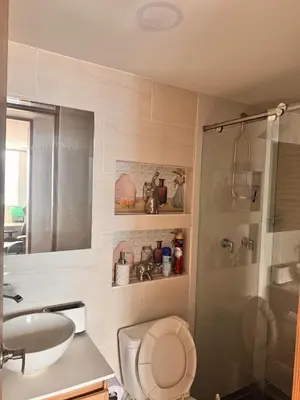 a bathroom with a toilet and a sink and a shower at Espectacular Habitacion Privada en Apartamento in Medellín