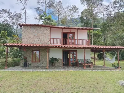a small house with a balcony on top of it at Rural Cabin Among Clouds in Támesis