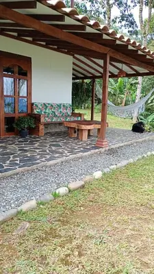 a pavilion with a bench on a patio at Rural Cabin Among Clouds in Támesis