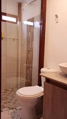 a bathroom with a toilet and a shower and a sink at Rural Cabin Among Clouds in Támesis