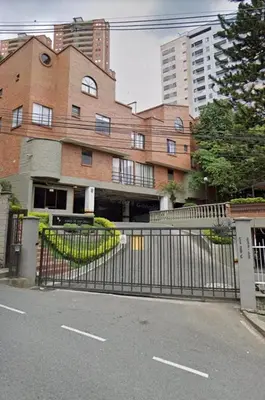 a gate in front of a building with buildings at Habitación Amoblada in Medellín