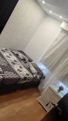 a small bedroom with a bed and a table at Habitación Amoblada in Medellín