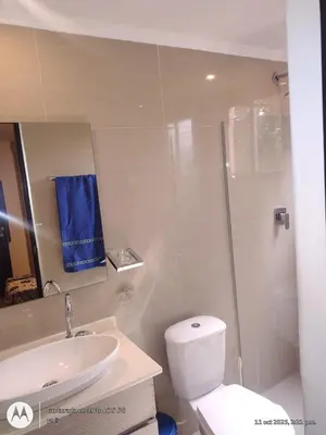 a bathroom with a toilet and a sink and a shower at Habitación Amoblada in Medellín