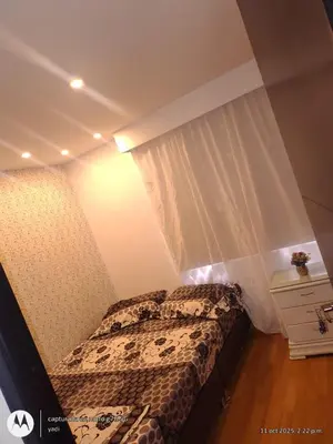 a small bedroom with a bed and a curtain at Habitación Amoblada in Medellín