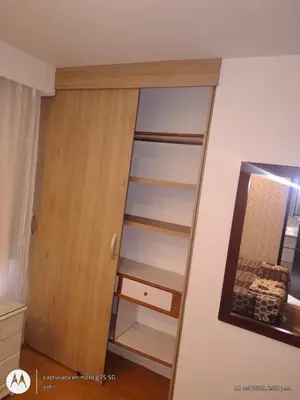 a closet with a mirror next to a door at Habitación Amoblada in Medellín
