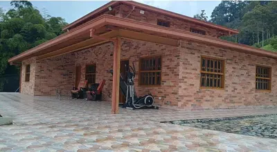 a brick building with a pavilion on a patio at Villa marinilla in Santuario