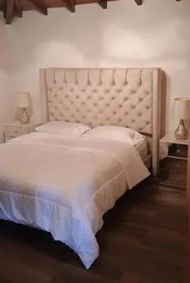 a bedroom with a large white bed with two lamps at Villa marinilla in Santuario