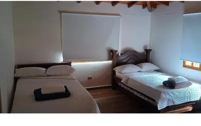 two beds sitting in a room withermottermott at Villa marinilla in Santuario