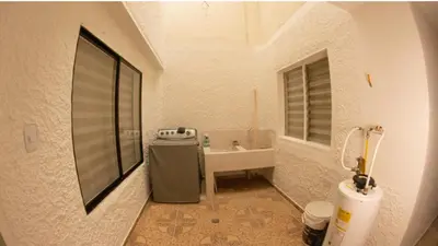 a bathroom with a sink and a toilet in a room at Acogedora casa Refugio del Altisimo in Medellín