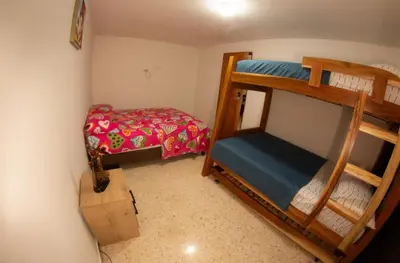 a small room with two bunk beds in it at Acogedora casa Refugio del Altisimo in Medellín
