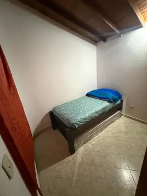 a small room with a bed in the corner at Casa Village in Guatapé