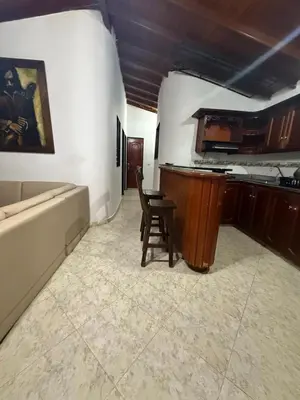 a kitchen with a table and a chair in a room at Casa Village in Guatapé