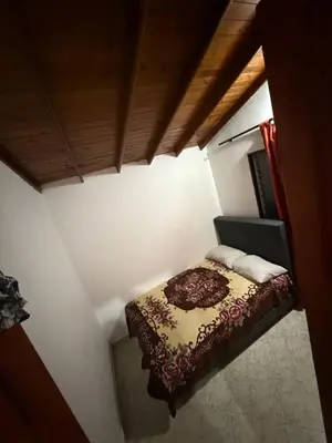 a small bedroom with a bed in a room at Casa Village in Guatapé