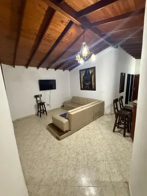 a living room with a couch and a table at Casa Village in Guatapé