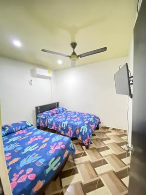 a bedroom with two beds and a ceiling fan at Apartamento Bustos 1 in Puerto Triunfo