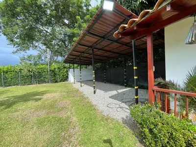 a building with awning next to a yard at Villa with pool, jacuzzi, Turkish bath, BBQ, kiosk, and green area in Sopetran