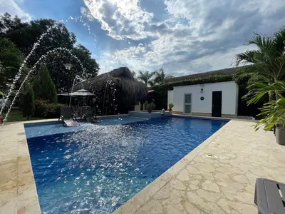 a swimming pool with a fountain in front of a house at Villa with pool, jacuzzi, Turkish bath, BBQ, kiosk, and green area in Sopetran