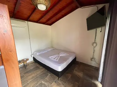a small bedroom with a bed in a room at Villa with pool, jacuzzi, Turkish bath, BBQ, kiosk, and green area in Sopetran